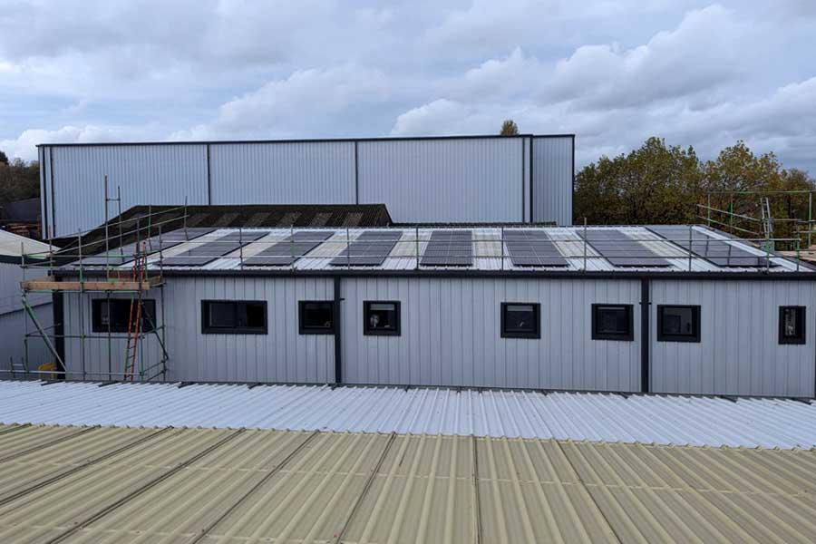 Solar panels installed on a metal roof of an industrial building